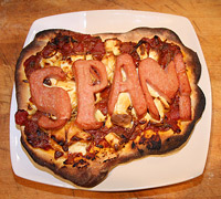 Photo of a pizza with Spam slices in the shape of the word "SPAM"